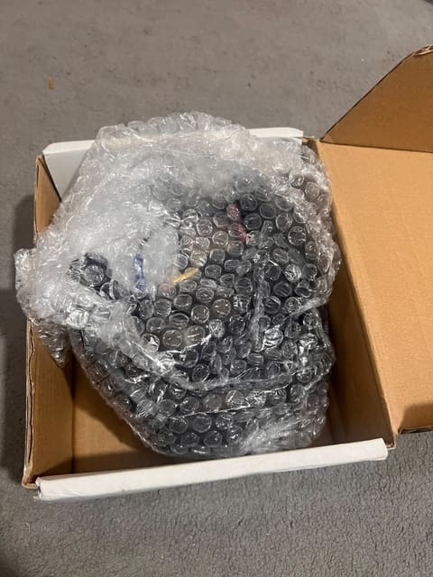 Audiometric headset bubble-wrapped inside its shipping box